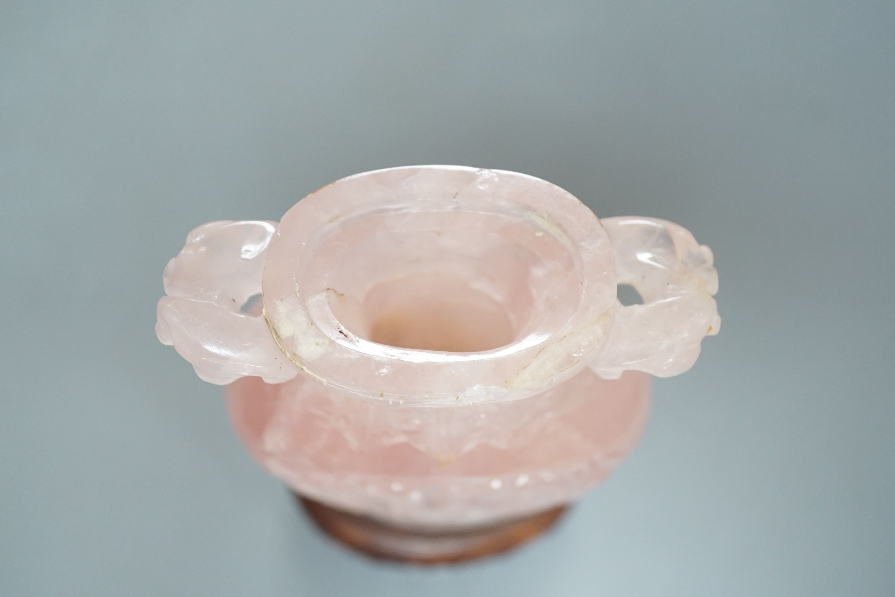 A late 19th/early 20th century Chinese carved rose quartz vase and cover, on a Hongmu stand, 23.5 cm high including stand.